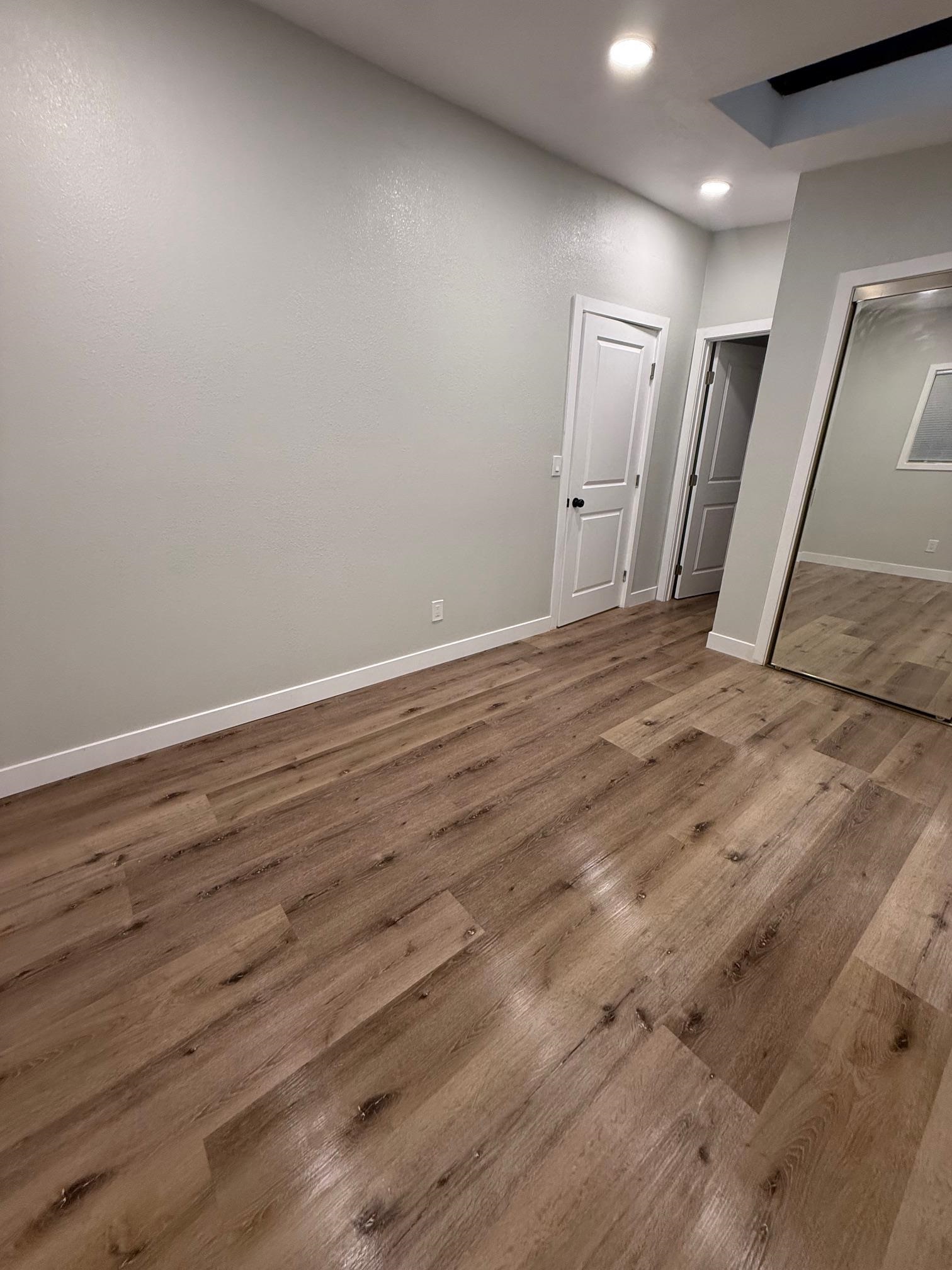 17028 Santa Fe Street Hayward, CA 94541 - Photo 37 of 54 a view of an empty room with wooden floor and a window