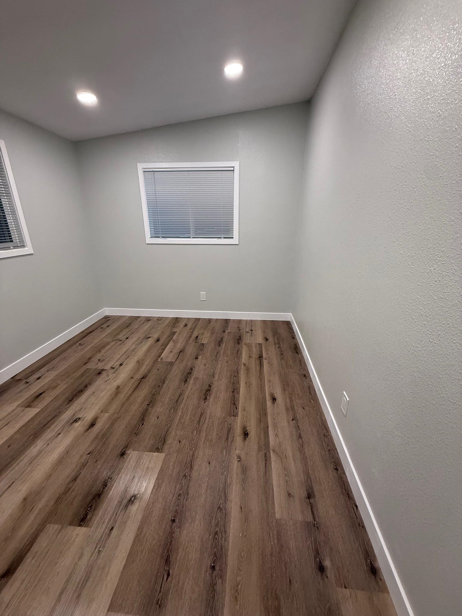 17028 Santa Fe Street Hayward, CA 94541 - Photo 39 of 54 an empty room with wooden floor and windows