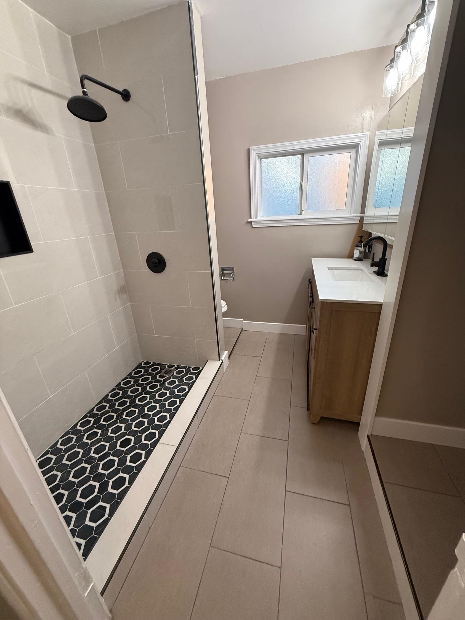 17028 Santa Fe Street Hayward, CA 94541 - Photo 9 of 54 a bathroom with a sink a toilet a mirror and shower