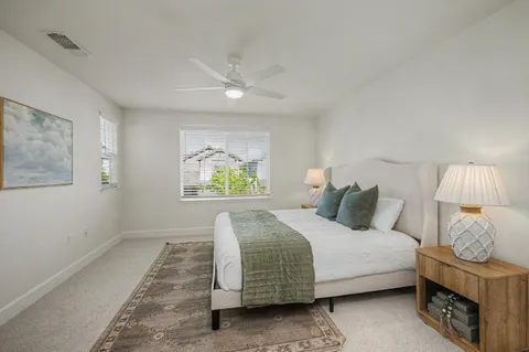 a bedroom with a bed and painting on the wall