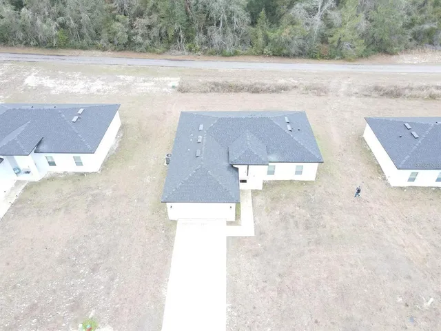 an aerial view of house with yard