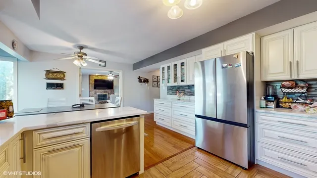 a kitchen with stainless steel appliances a refrigerator sink and stove