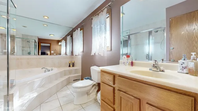 a bathroom with a sink a toilet a mirror and bathtub