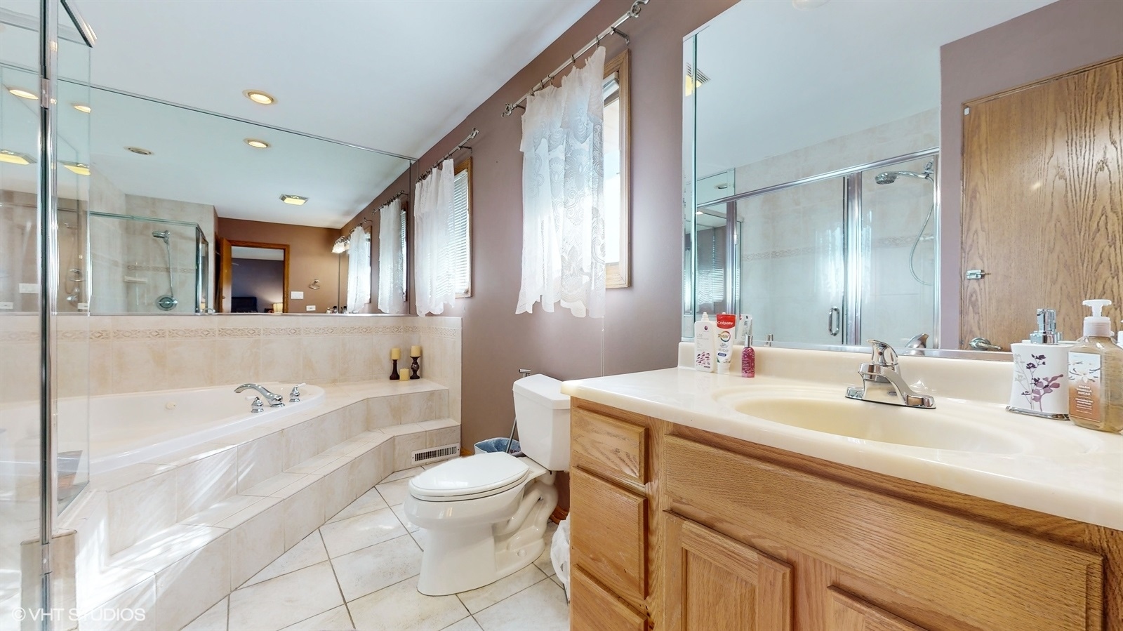 14467 Creekview Drive Orland Park, IL 60467 - Photo 24 of 51 a bathroom with a sink a toilet a mirror and bathtub