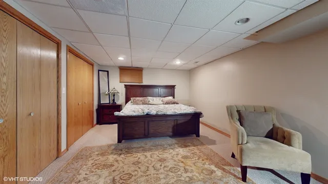 a bedroom with a large bed and a dresser