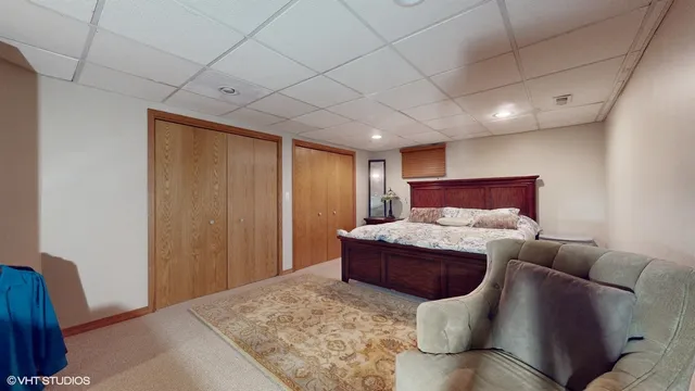 a bedroom with a large bed and a chandelier