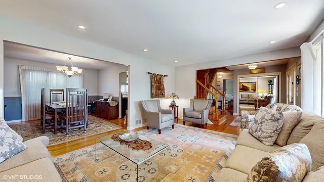a living room with furniture a dining table and chairs with kitchen view