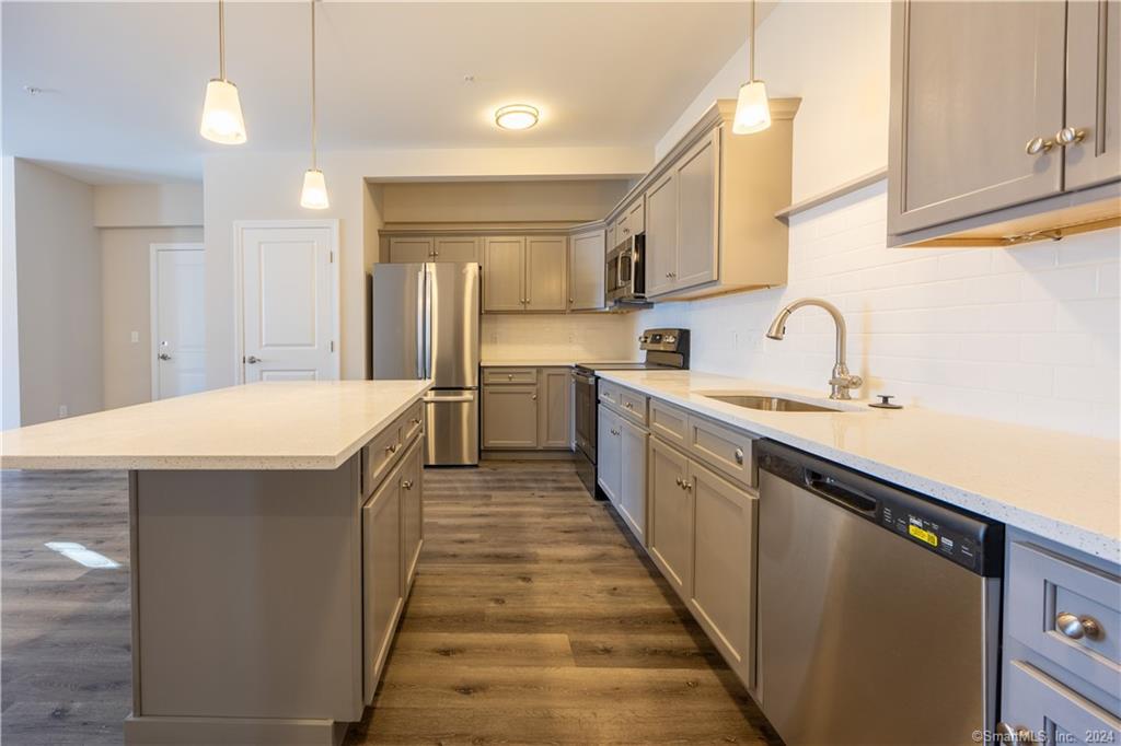 64 East Mitchell Avenue, Unit 27 Cheshire, CT 06410 - Photo 4 of 17 a kitchen with stainless steel appliances a sink stove and cabinets