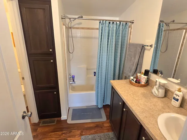 a bathroom with sink a mirror a bathtub and shower