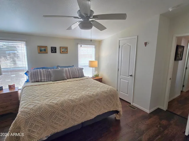 a bedroom with a large bed and a chandelier