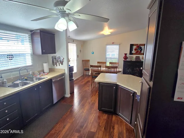 a large kitchen with stainless steel appliances wooden floors and wooden cabinets