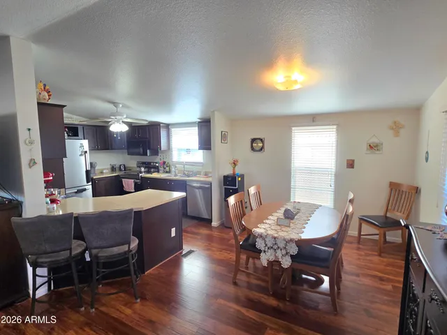 a view of a dining room with furniture and wooden floor