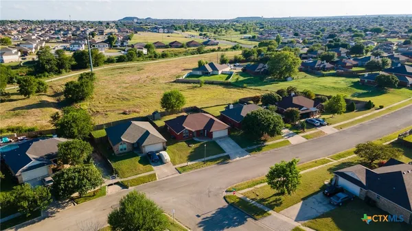 an aerial view of residential houses with outdoor space