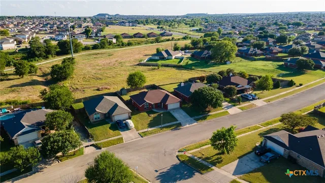 an aerial view of residential houses with outdoor space