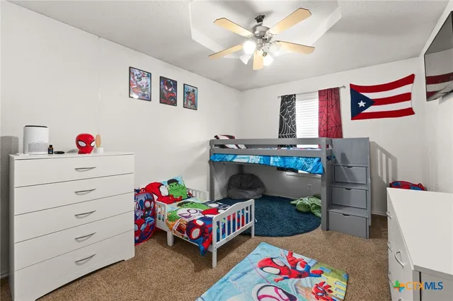 a bedroom with furniture and a baby crib