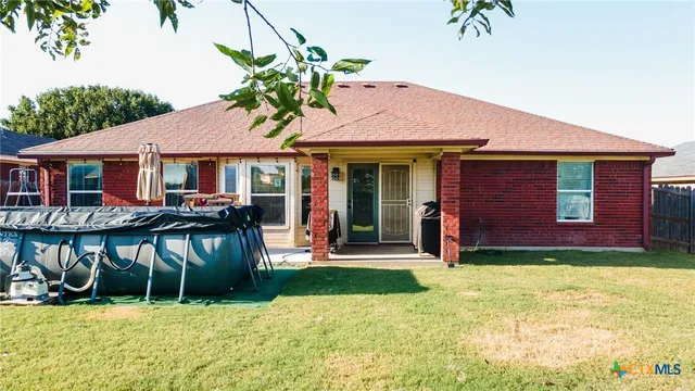 a front view of a house with yard porch and furniture