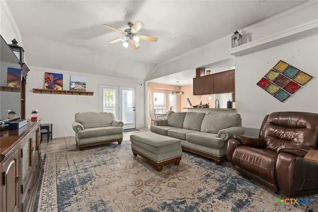 a living room with furniture and a chandelier