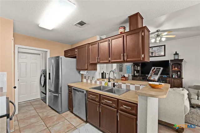a kitchen with a sink stainless steel appliances and cabinets
