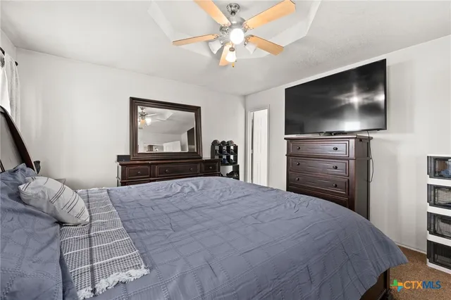 a bedroom with a bed and a flat screen tv