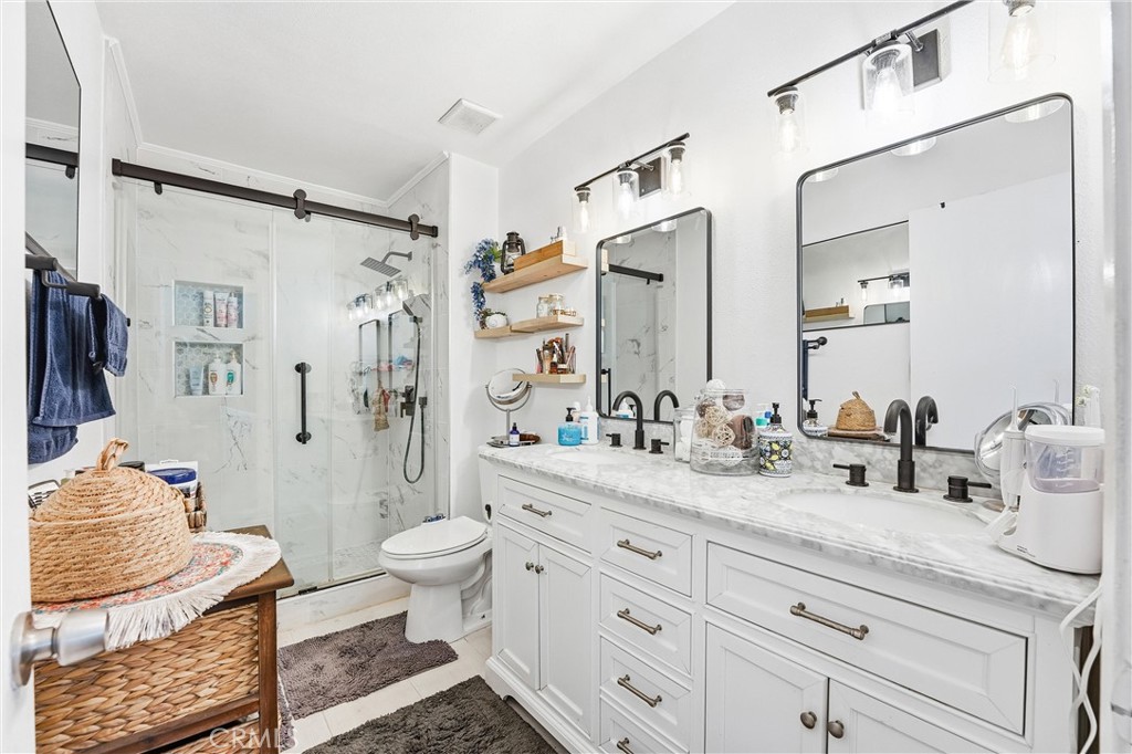 11908 Fallingleaf Circle Garden Grove, CA 92840 - Photo 14 of 30 a bathroom with a granite countertop sink mirror vanity and toilet