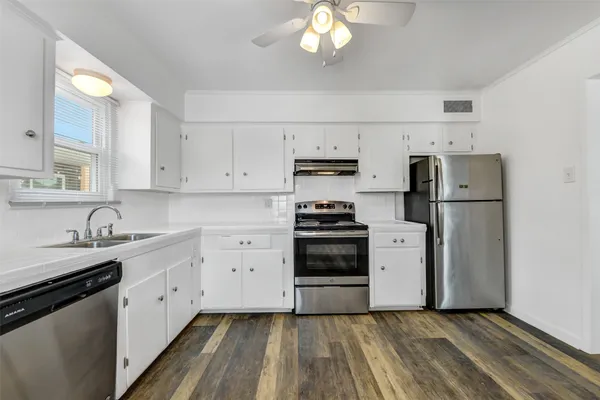 a kitchen with a stove and a refrigerator