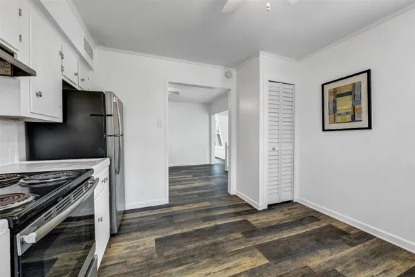 a view of wooden floor and chandelier fan in a room
