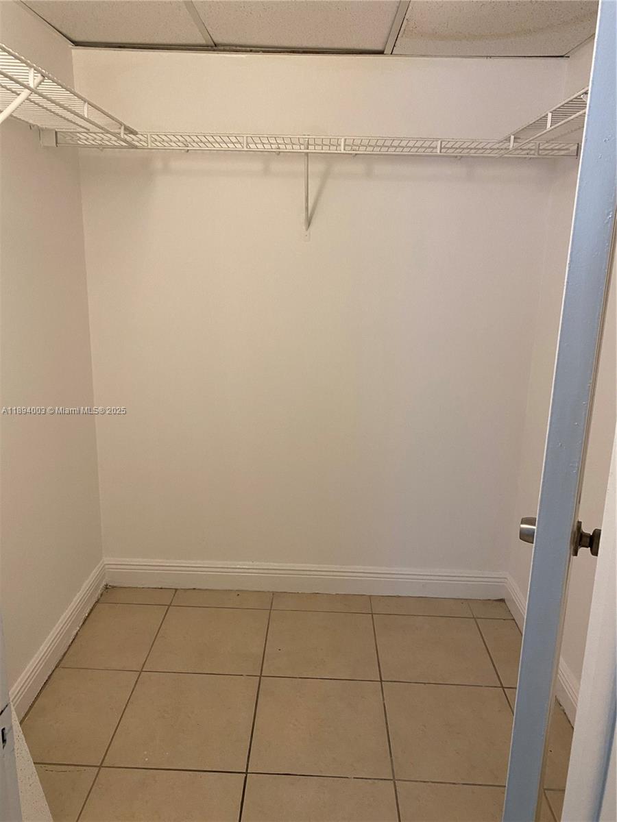 4453 Treehouse Lane, Unit C Tamarac, FL 33319 - Photo 12 of 21 a view of a room with racks on the wall