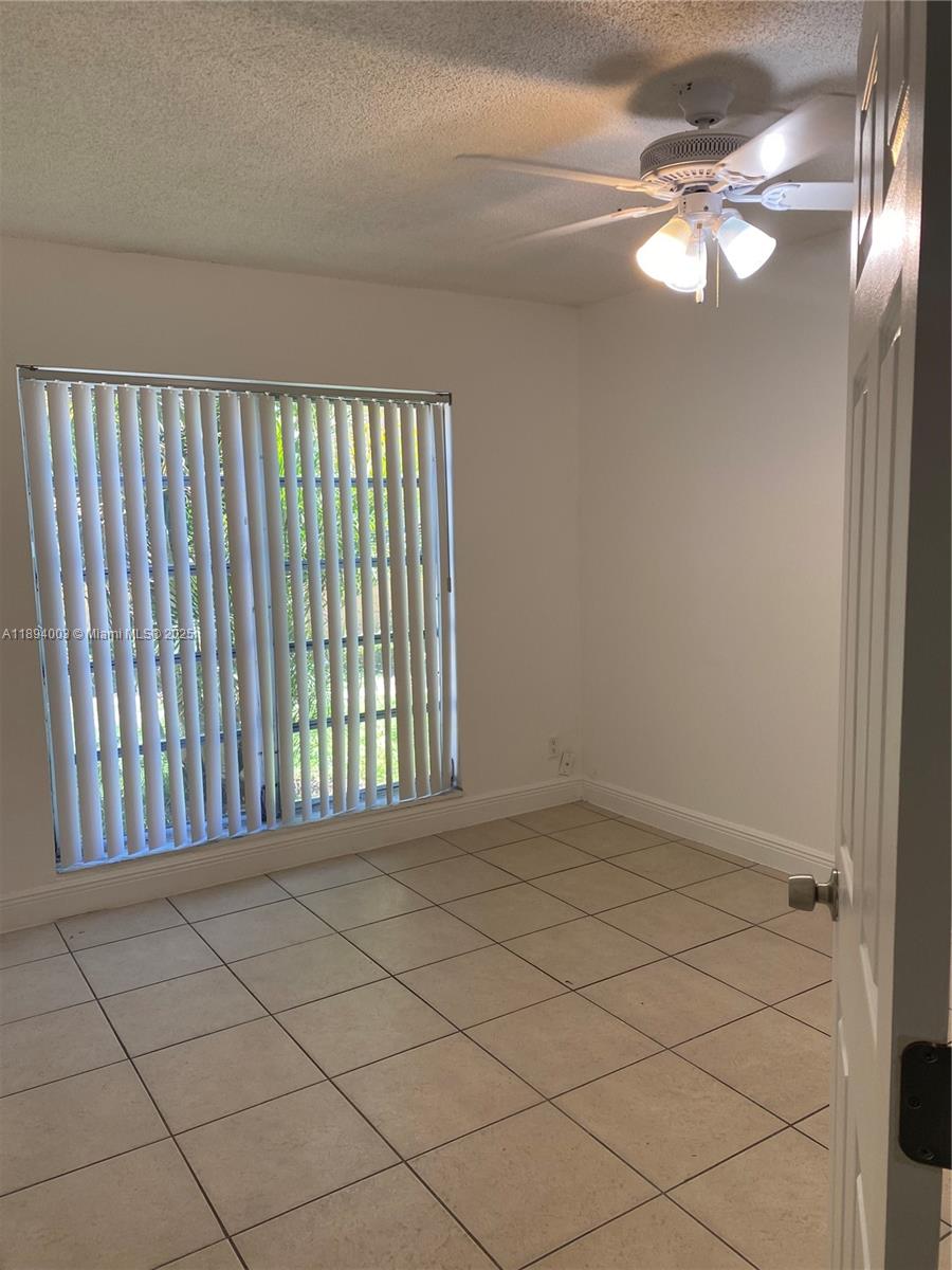 4453 Treehouse Lane, Unit C Tamarac, FL 33319 - Photo 13 of 21 a view of an empty room and window