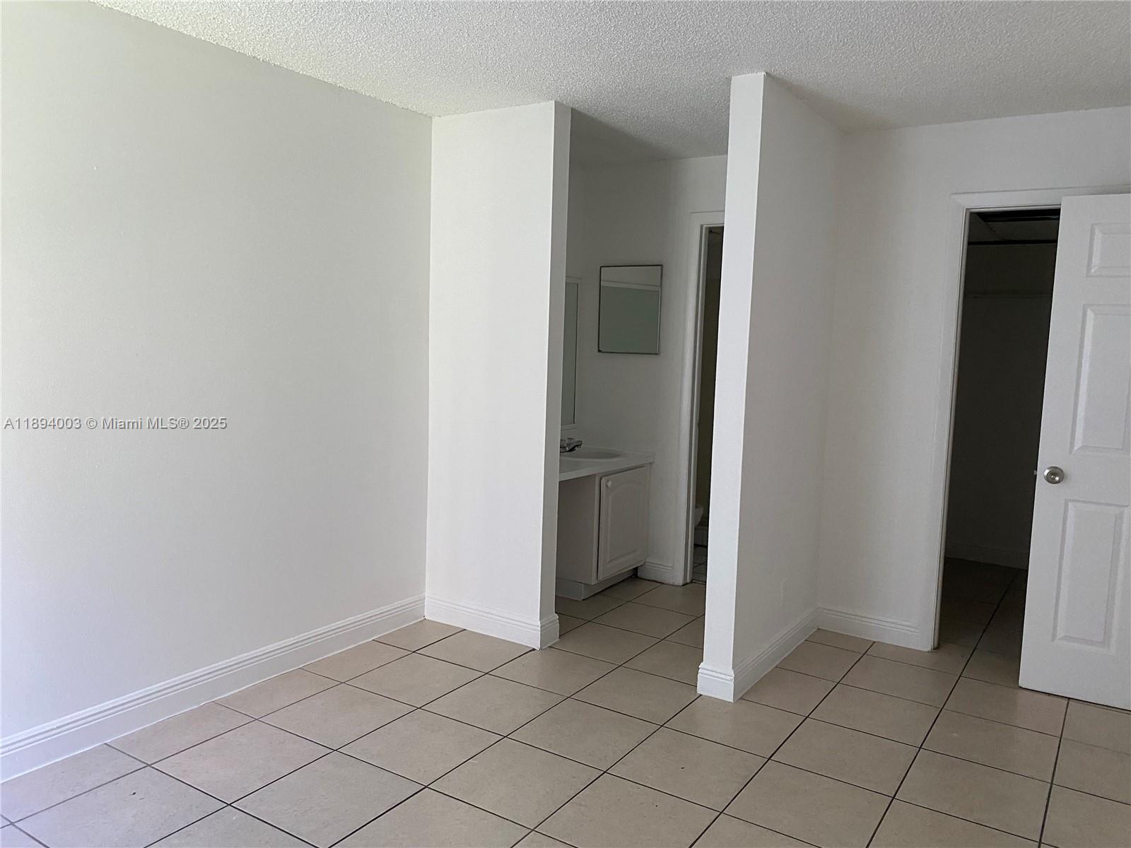 4453 Treehouse Lane, Unit C Tamarac, FL 33319 - Photo 6 of 21 a view of an empty room and closet area