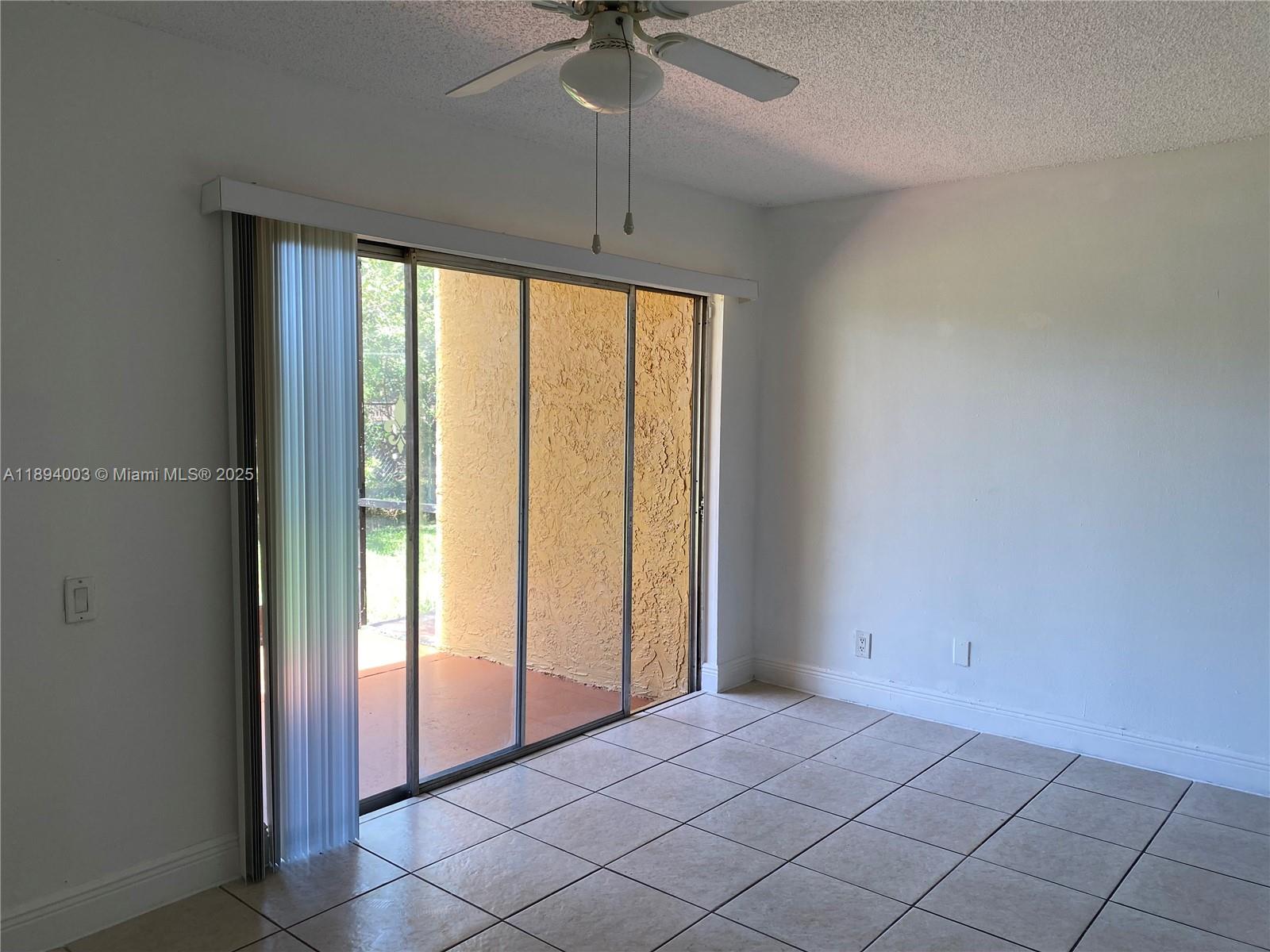 4453 Treehouse Lane, Unit C Tamarac, FL 33319 - Photo 8 of 21 a view of a room with window and a ceiling fan