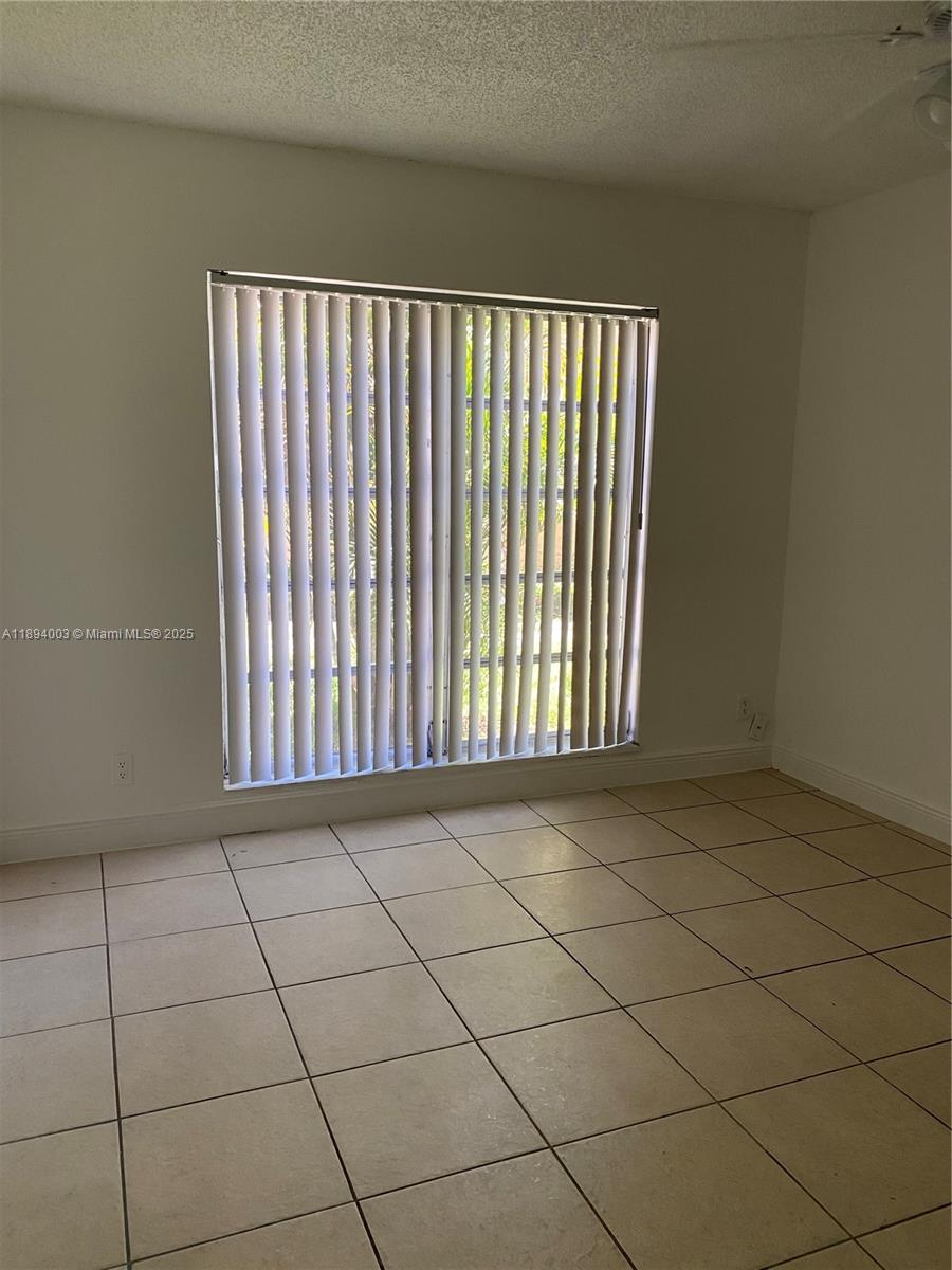 4453 Treehouse Lane, Unit C Tamarac, FL 33319 - Photo 10 of 21 a view of a black and white floor to ceiling window