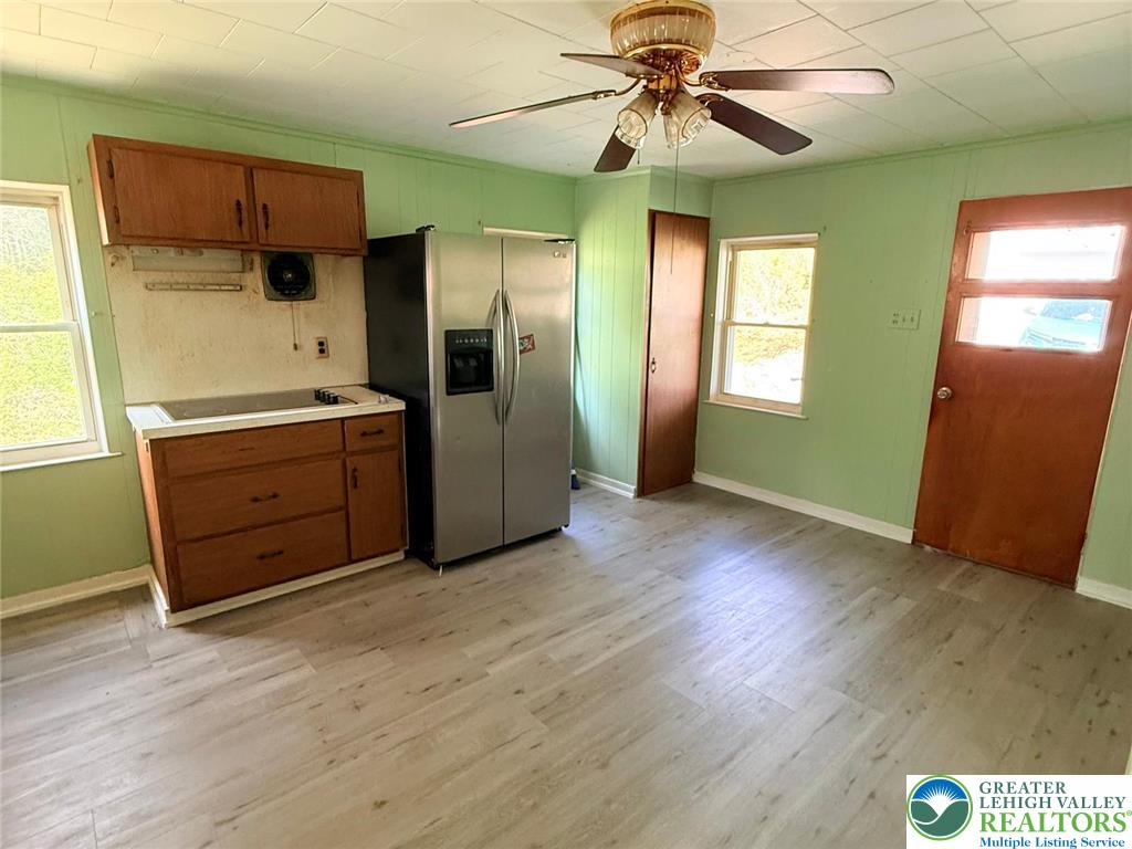 3420 Little Gap Road Palmerton, PA 18071 - Photo 12 of 26 an empty room with wooden floor cabinet and windows