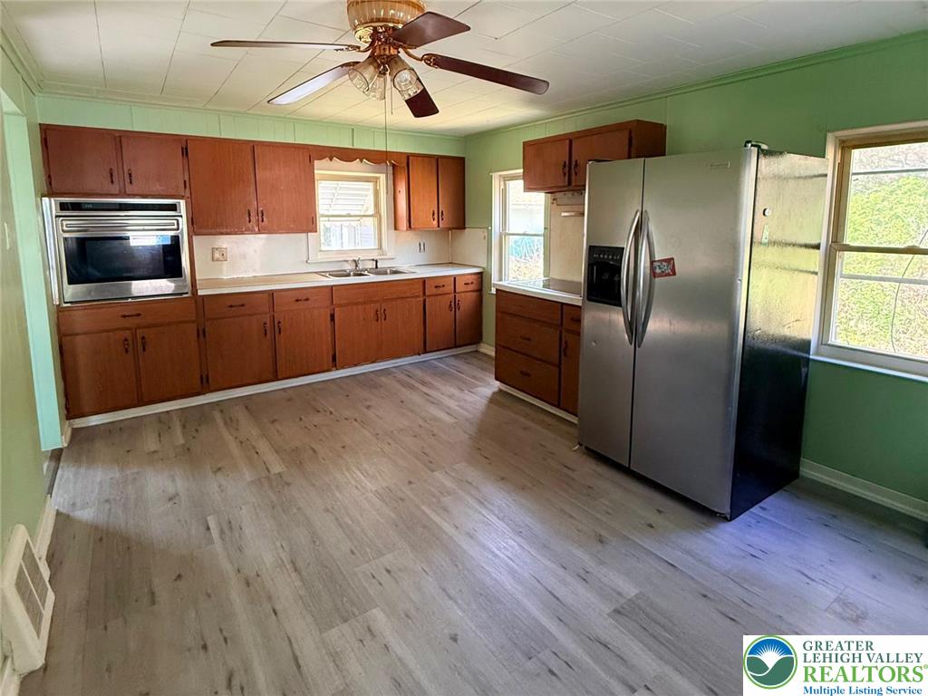 3420 Little Gap Road Palmerton, PA 18071 - Photo 13 of 26 a kitchen with stainless steel appliances wooden floors and wooden cabinets