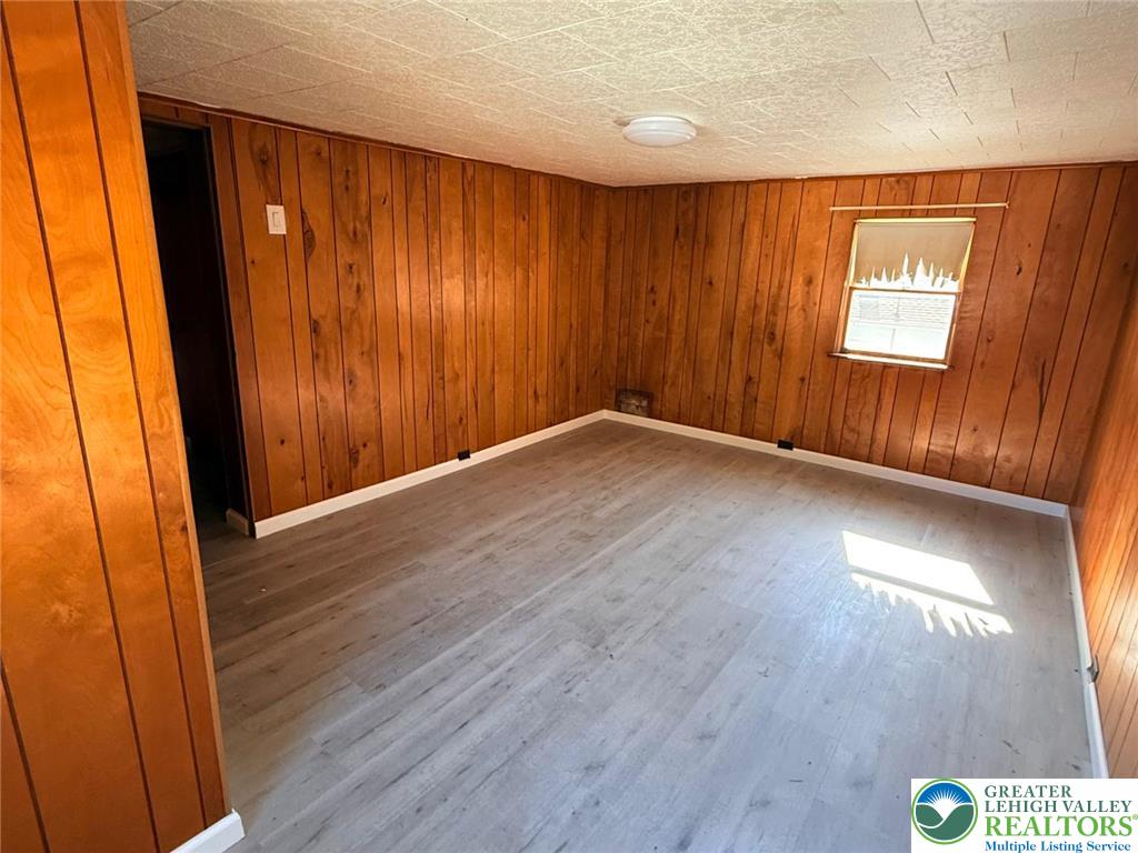 3420 Little Gap Road Palmerton, PA 18071 - Photo 22 of 26 an empty room with wooden floor and windows