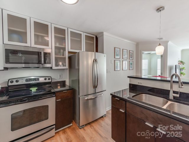 a kitchen with granite countertop stainless steel appliances and wooden cabinets