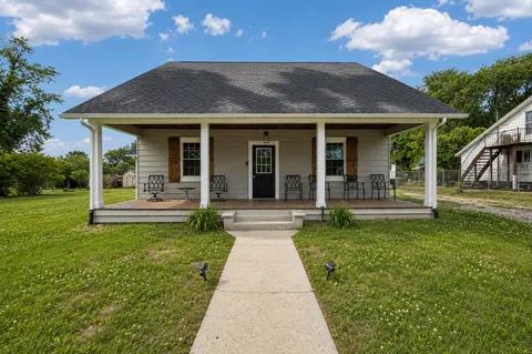 a view of a house with garden and a porch