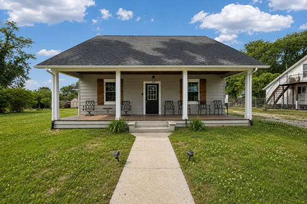 a view of a house with garden and a porch