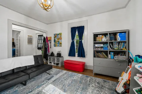 a living room with furniture and a book shelf