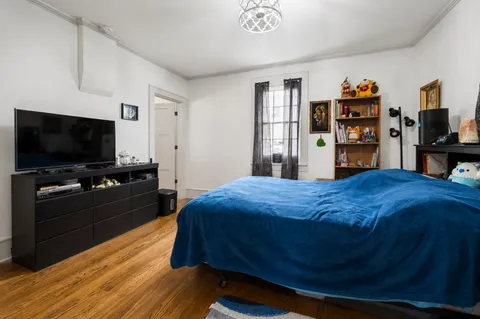 a bedroom with a bed and a flat screen tv