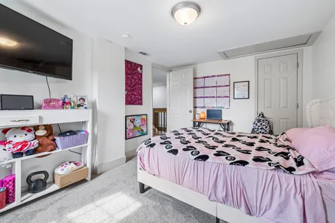 a bedroom with a bed and a flat screen tv