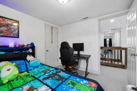 a bedroom with bed and flat screen tv