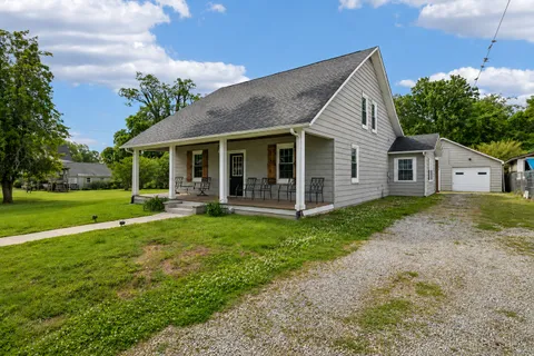 a view of a house with backyard porch and garden