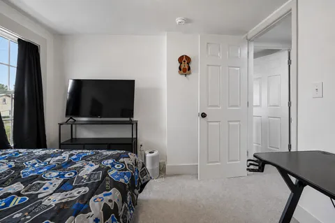 a room with furniture and a flat screen tv