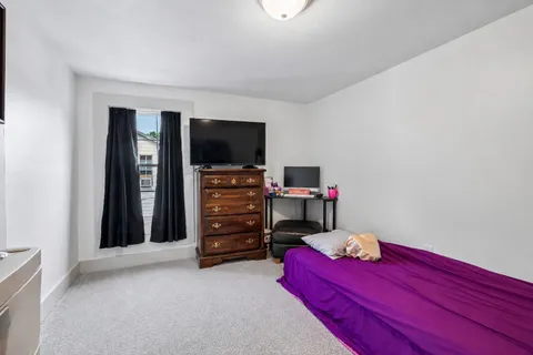 a view of walk in closet with clothes