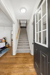 a view of entryway and hall with wooden floor