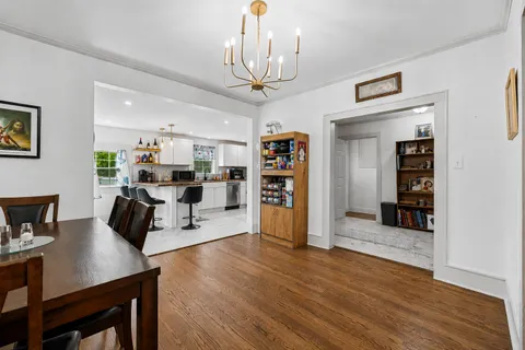 a living room with furniture and view of kitchen
