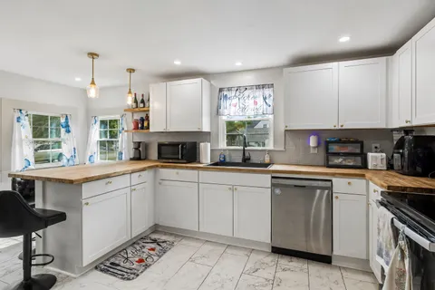 a kitchen with a sink cabinets and window