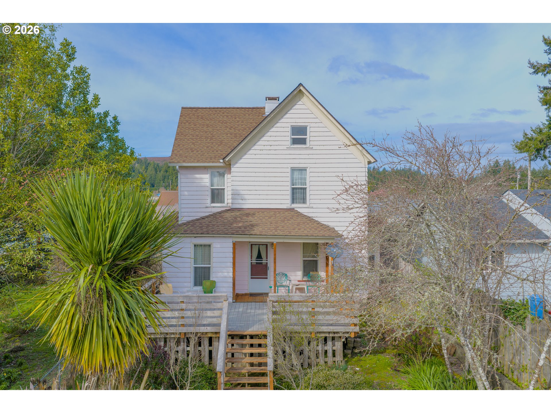 1150 West 8th Street Coquille, OR 97423 - Photo 2 of 42 a front view of a house with a garden