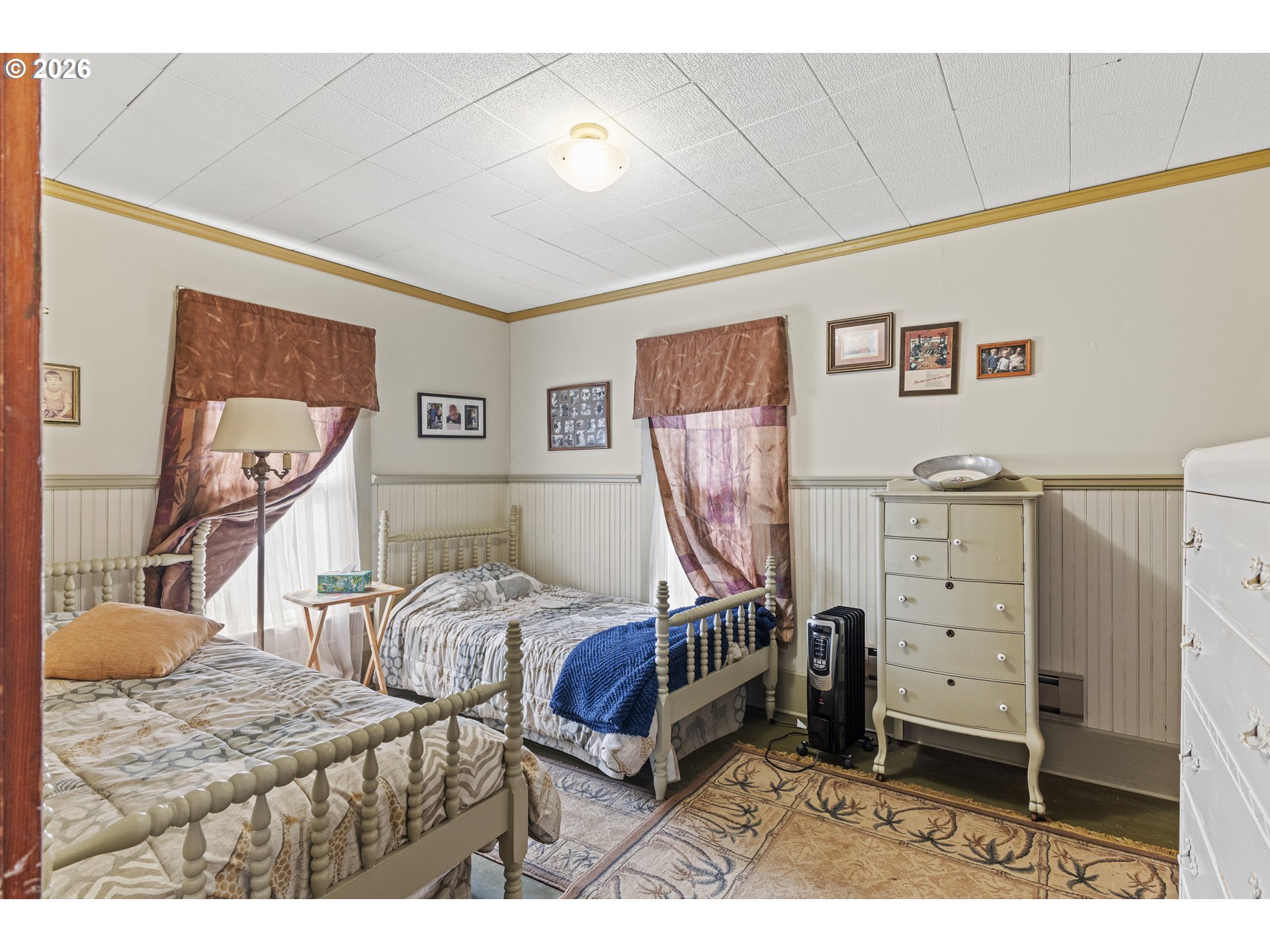 1150 West 8th Street Coquille, OR 97423 - Photo 32 of 42 a bedroom with furniture and a large window