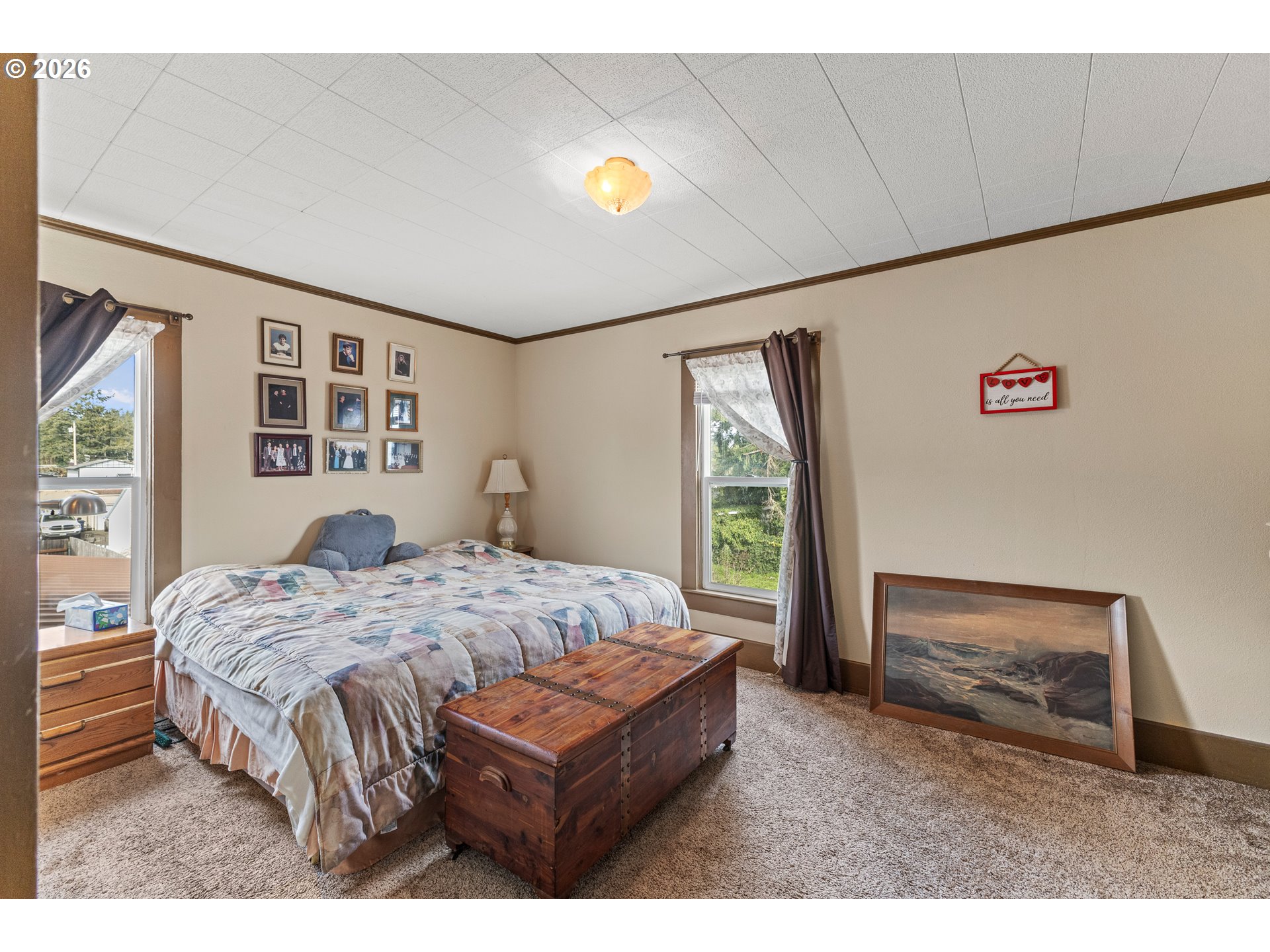 1150 West 8th Street Coquille, OR 97423 - Photo 36 of 42 a bed sitting in a bedroom next to a window